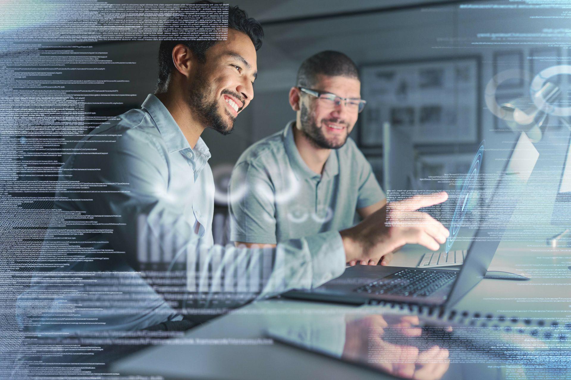 Two men smiling looking at a computer